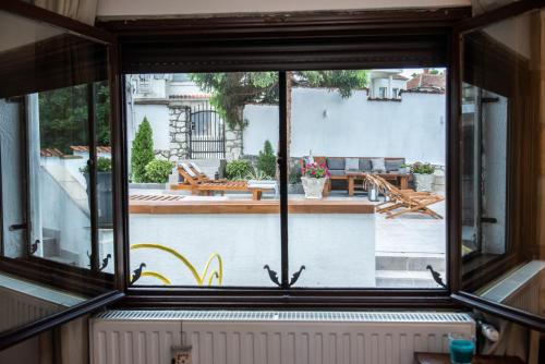 a window in a house looking out onto a patio at Vila Mila in Arandjelovac
