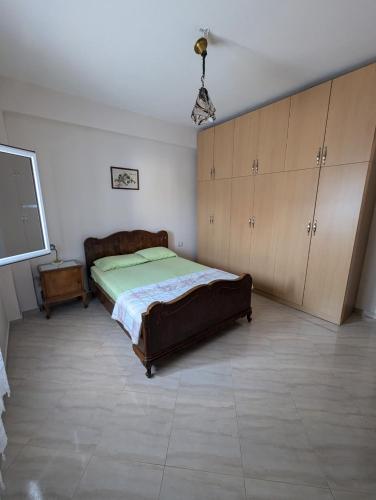 a bedroom with a bed and cabinets and a tv at Monastery Inn in Nartë