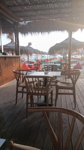 a group of tables and chairs on a deck at A-Vila in Golem
