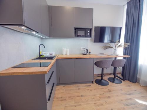 a kitchen with a sink and a counter at Smart House Apartments in Lviv