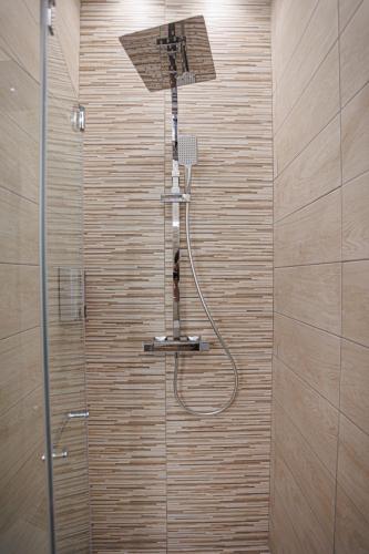 a shower with a shower head in a bathroom at Monia Rooms&Hospitality in Piazza Armerina