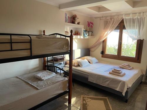 a bedroom with two bunk beds and a window at IslandTime Studio2 in Prinos