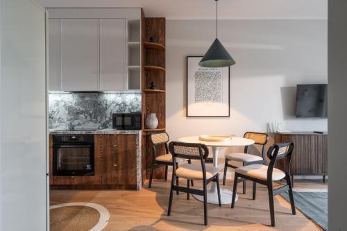 a kitchen and dining room with a table and chairs at RentPlanet - Kępa Mieszczańska in Wrocław