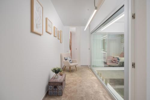 a living room with a window and a chair at Fahana Las Canteras in Las Palmas de Gran Canaria