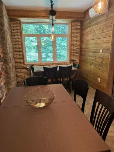 a dining room with a wooden table and chairs at The Forest Villa Borovets by BookVillaBG in Borovets