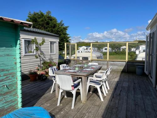 a wooden deck with a table and chairs on it at Summer house on the Dutch coast in IJmuiden