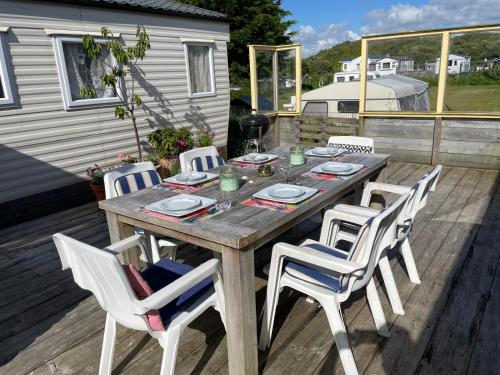 a wooden table and chairs on a deck at Summer house on the Dutch coast in IJmuiden