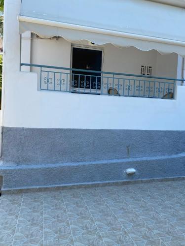 a building with a balcony with a blue light at Studio Mare in Megalochori