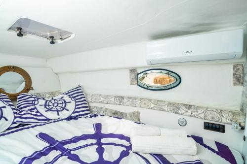 a bedroom with a bed with blue and white pillows at Etna's boat house in Piedimonte Etneo