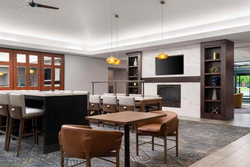 a dining room with a bar and a fireplace at Homewood Suites by Hilton Hartford South-Glastonbury in Glastonbury