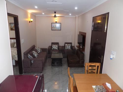 a living room with a couch and a table at Homestay with Ravinder 2BHK in Paikbara