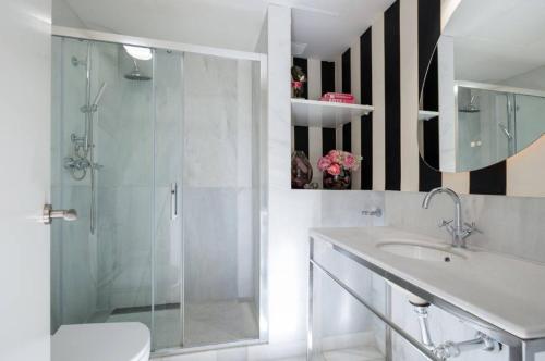a bathroom with a shower and a toilet and a sink at Art Suite Granada in Granada