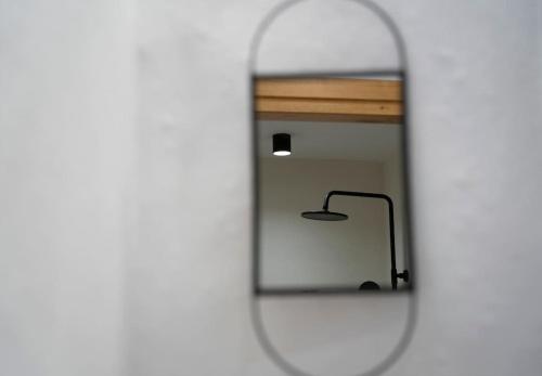 a mirror with a reflection of a chair in it at Olea Luxury Apartment With Great View in Ierápetra