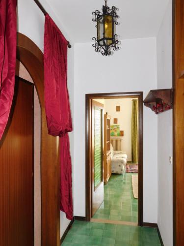 a hallway with red drapes on the doors of a house at Villa Maria Lake View,7 minuti a piedi dal centro, parcheggio privato in Torri del Benaco