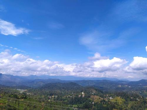 a view of the mountains with a blue sky and clouds at White Home in Haputale
