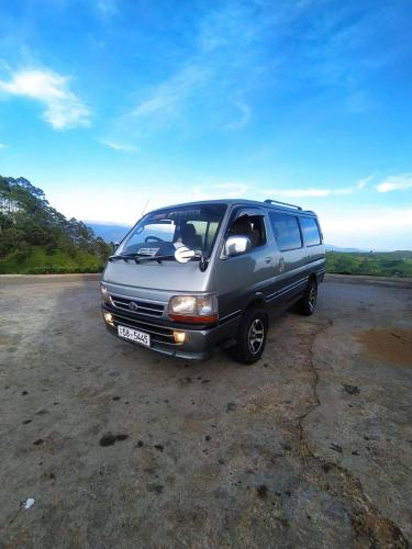 a minivan parked on the side of a road at White Home in Haputale