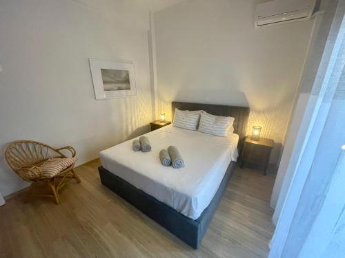 a bedroom with a bed with two shoes on it at Stella's Petite Boîte in Rafina