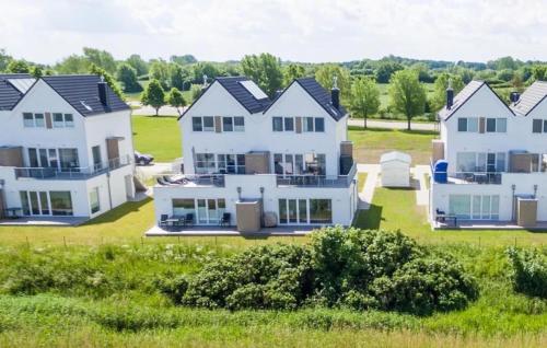 a group of white houses in a field at Fiete in Olpenitz
