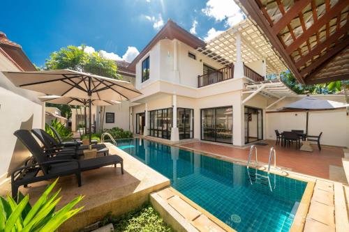 a villa with a swimming pool and a house at Angsana Villas Laguna-3 Bedroom Pool Villa in Phuket