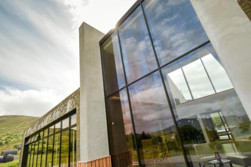 a building with large glass windows on the side of it at Bracken Hide Hotel in Portree