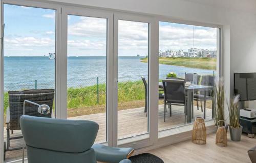a room with sliding glass doors with a view of the ocean at Schlei Oase in Olpenitz