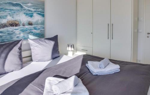 a bedroom with a bed with towels on it at Schlei Oase in Olpenitz