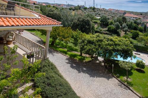an aerial view of a house with a pool and trees at Recanto Transmontano in Macedo de Cavaleiros