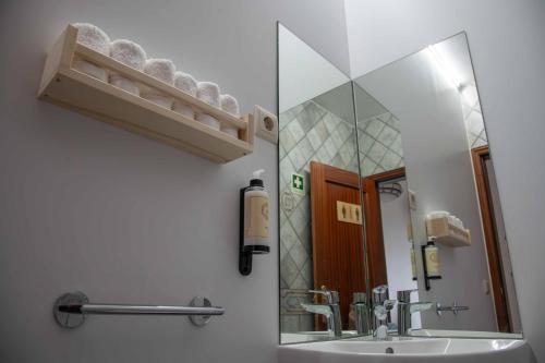 a bathroom with a sink and a mirror at Recanto Transmontano in Macedo de Cavaleiros