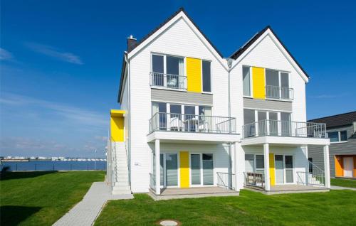 une grande maison blanche aux volets jaunes dans l'établissement La Maisonnette, à Olpenitz