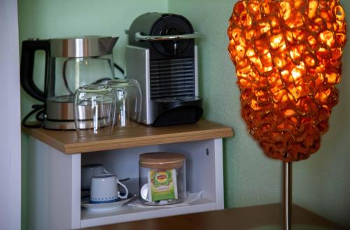 a shelf with a coffee maker and a blender at Recanto Transmontano in Macedo de Cavaleiros