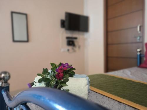 a potted plant sitting on a table in a bedroom at Kanna Garden by Bodhi Bungalows in Kolli Hills