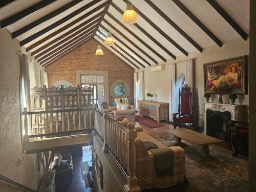 a living room with a couch and a fireplace at Castle Home in Centurion