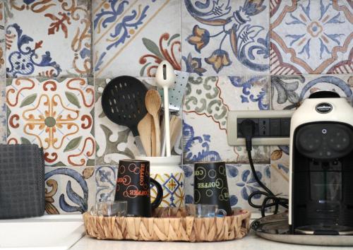 a kitchen counter with a coffee maker and utensils at Giosalea Tropea in Tropea