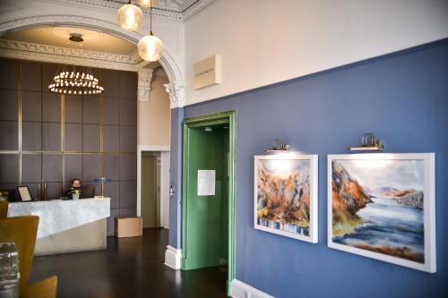 a lobby with two paintings on the wall at The Perle Oban Hotel & Spa in Oban
