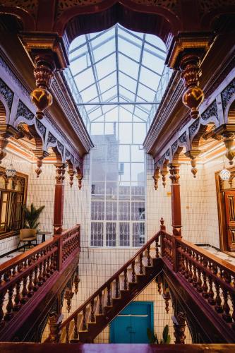 an ornate staircase in a building with a large window at 寻疆别苑民宿 Kashgar Ancient City Scenic Area in Kashgar