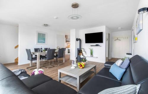 a living room with a couch and a table at Schleijuwel in Olpenitz