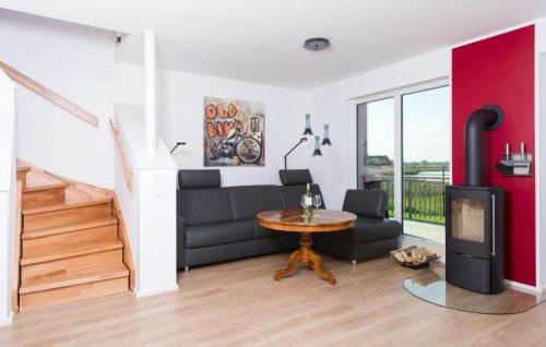 a living room with a couch and a table at Villa Seensucht in Olpenitz
