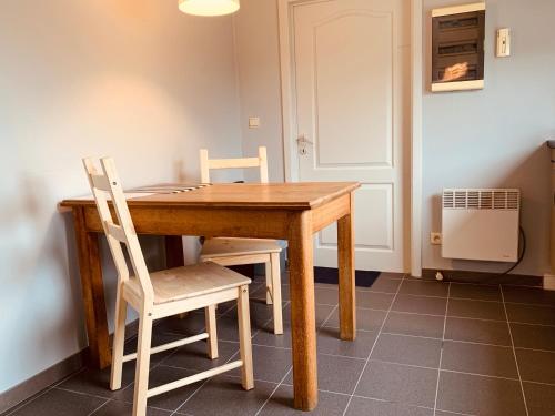 a dining room table with two chairs and a table at Meuse Riverside in Hastière-par-delà