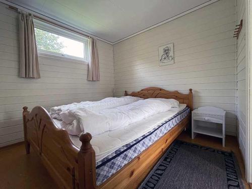 a large bed in a room with a window at Selje Camping - Hytte Nr 4 in Selje