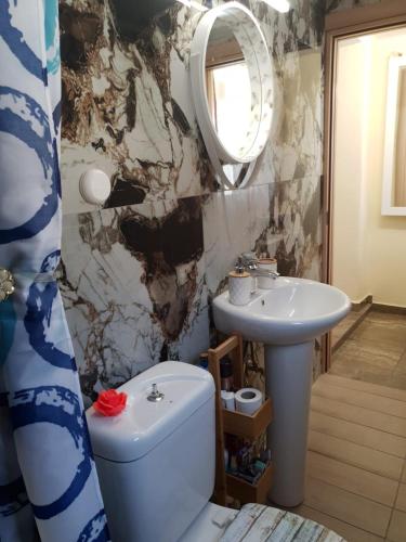 a bathroom with a toilet and a sink at IslandTime Studio2 in Prinos