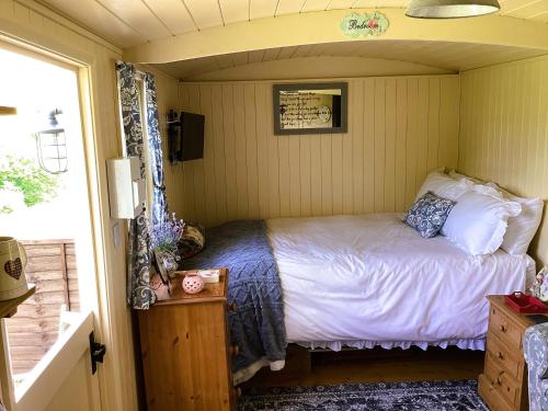 a bedroom with a bed in a small room at Lilly's Pad in Bude