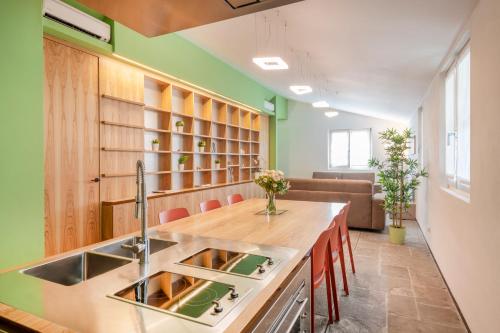a kitchen with a sink and a counter with chairs at JOIVY Charming Portofino 3-bed retreat in Portofino
