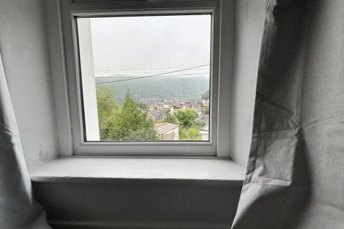 an open window with a view of a city at Cottage in Llanberis in Llanberis