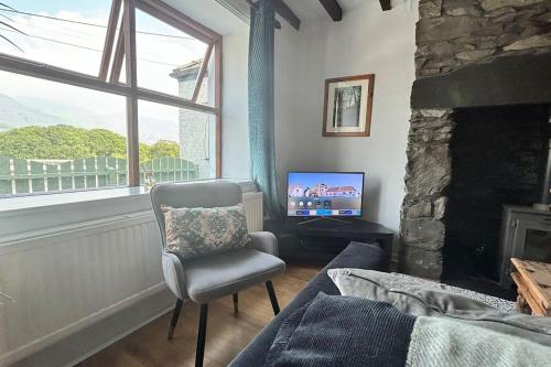a living room with a chair and a television at Cottage in Llanberis in Llanberis