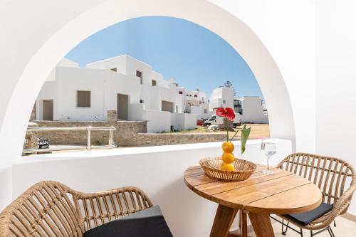 a table and chairs on a balcony with a view at Perla Hotel in Agios Prokopios