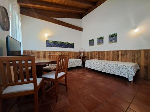 a room with a table and a bed and chairs at Corte San Mattia in Verona