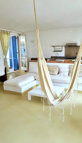 a hammock in a room with two beds at Surf House Casa Vehla in Sal Rei