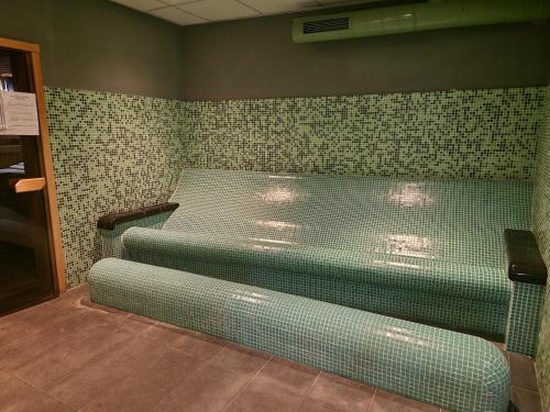 a room with two beds in a room with tiles at MPM Hotel Arsena - Ultra All Inclusive in Nesebar
