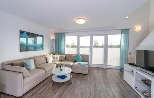 a living room with a couch and a table at Flamingo in Olpenitz