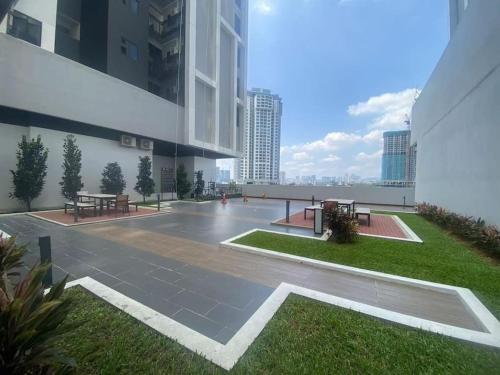 a courtyard of a building with benches and tables at Platinum Arena Old Klang Road Midvalley in Kuala Lumpur